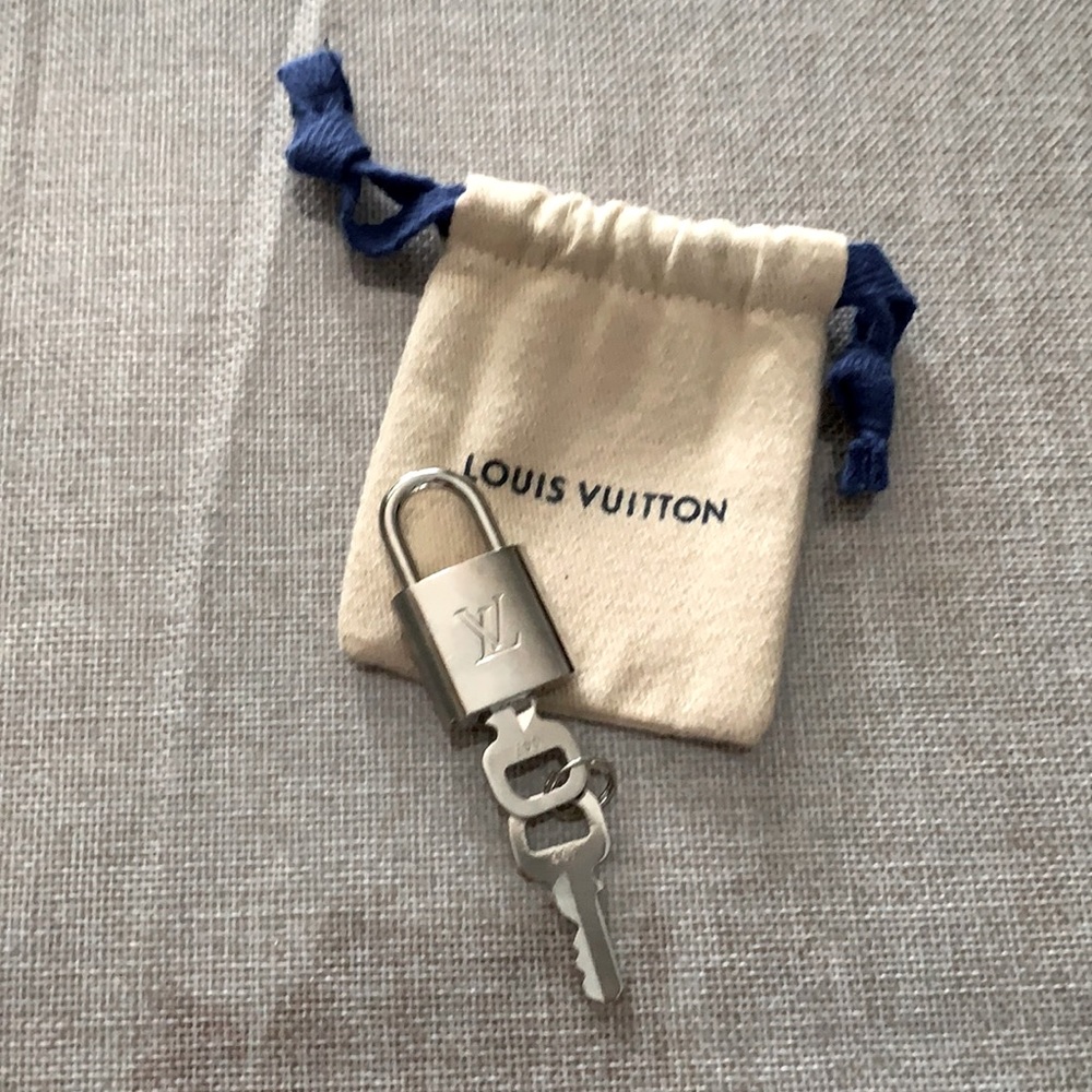 Louis Vuitton lock and key. New never used. Can use as pendant around neck.